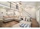 Open-concept living room with a view of the staircase and a large comfortable sectional sofa at 170 Charlotte Blvd, Stockbridge, GA 30281