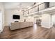 Spacious living room with high ceilings, a fireplace, hardwood floors, and a large sectional sofa at 170 Charlotte Blvd, Stockbridge, GA 30281