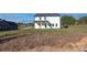 Spacious backyard view showcasing the home's exterior and its large grassy yard at 3563 New Hope Rd, Dacula, GA 30019
