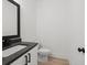 Modern half bathroom featuring a granite countertop and sleek black hardware at 3563 New Hope Rd, Dacula, GA 30019