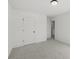 Carpeted bedroom with white trim and walls, leading to an open doorway to another room at 3563 New Hope Rd, Dacula, GA 30019