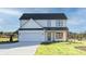 Charming two-story white home featuring a two car garage and manicured lawn at 3563 New Hope Rd, Dacula, GA 30019