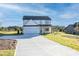 New construction home featuring a manicured lawn, concrete driveway, and a two-car garage at 3563 New Hope Rd, Dacula, GA 30019
