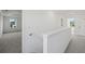 Upstairs hallway leading to a bedroom with plush gray carpet and white trim at 3563 New Hope Rd, Dacula, GA 30019