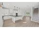 Bright kitchen featuring white cabinets, granite countertops, stainless steel appliances, and hardwood floors at 3563 New Hope Rd, Dacula, GA 30019