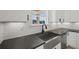 Kitchen featuring granite countertops, white cabinets, and stainless steel sink at 3563 New Hope Rd, Dacula, GA 30019