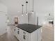 Bright kitchen featuring a center island, modern lighting, and an open floor plan at 3563 New Hope Rd, Dacula, GA 30019