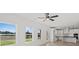Open-concept living area with large windows offering scenic views and a modern ceiling fan at 3563 New Hope Rd, Dacula, GA 30019
