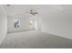 Spacious main bedroom featuring tray ceiling, neutral carpet, and abundant natural light at 3563 New Hope Rd, Dacula, GA 30019