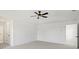 Main bedroom features neutral paint, carpet, and a tray ceiling with modern fan at 3563 New Hope Rd, Dacula, GA 30019