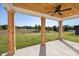 Covered porch with wooden columns, a ceiling fan, and a view of the expansive backyard at 3563 New Hope Rd, Dacula, GA 30019