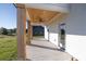 Covered porch with wooden columns, ceiling fan, and a view of the surrounding greenery at 3563 New Hope Rd, Dacula, GA 30019