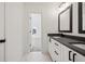 Bathroom featuring double sink vanity with black hardware and granite counters at 3567 New Hope Rd, Dacula, GA 30019