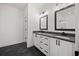 Bathroom with double vanities, granite countertops, and sleek black accents at 3567 New Hope Rd, Dacula, GA 30019