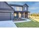 Inviting two-story home showcasing a lovely front yard, a paved walkway, and a convenient two-car garage at 3567 New Hope Rd, Dacula, GA 30019