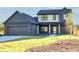 Charming two-story home featuring a well-manicured lawn, a two-car garage, and a welcoming front porch at 3567 New Hope Rd, Dacula, GA 30019