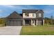Beautiful two-story home featuring natural wood accents, black brick facade, and a well-manicured lawn at 3567 New Hope Rd, Dacula, GA 30019