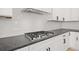 Modern kitchen features a gas cooktop and white cabinets at 3567 New Hope Rd, Dacula, GA 30019