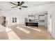 Open-concept living room featuring hardwood floors, coffered ceilings, and a gourmet kitchen at 3567 New Hope Rd, Dacula, GA 30019
