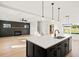 Spacious open floor plan features black accent wall and kitchen island at 3567 New Hope Rd, Dacula, GA 30019