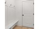 Mudroom area features coat hooks, built-in bench, and a white door at 3567 New Hope Rd, Dacula, GA 30019