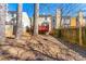 Wide backyard with trees and a red deck is partially covered in dried leaves at 1381 Vintage Pointe Dr, Lawrenceville, GA 30044