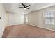 Spacious bedroom features neutral walls, carpet, and a ceiling fan at 1381 Vintage Pointe Dr, Lawrenceville, GA 30044