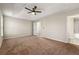 Primary bedroom with neutral walls and carpet leads to a connected bathroom at 1381 Vintage Pointe Dr, Lawrenceville, GA 30044
