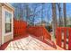 Wooden deck with red-painted railing and a view to the wooded backyard at 1381 Vintage Pointe Dr, Lawrenceville, GA 30044