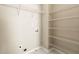 Functional laundry room with shelving for organized storage at 1381 Vintage Pointe Dr, Lawrenceville, GA 30044