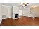 Open-concept living room with a fireplace and hardwood floors at 1381 Vintage Pointe Dr, Lawrenceville, GA 30044