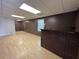Spacious basement with wood-look floors, neutral walls, and a brick bar area at 32 Ne Moriah Way, Rydal, GA 30171