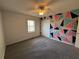 Bedroom featuring geometric wall decor, neutral carpet, and a closet at 32 Ne Moriah Way, Rydal, GA 30171