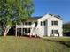 Charming two-story home with white siding, black shutters, and a spacious front yard at 32 Ne Moriah Way, Rydal, GA 30171