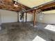 Exposed garage with concrete floors and exposed ceiling and structural supports at 32 Ne Moriah Way, Rydal, GA 30171