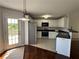 Bright kitchen featuring white cabinets, stainless steel appliances, and tile flooring at 32 Ne Moriah Way, Rydal, GA 30171