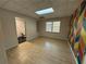 Office space with wood-look floors and colorful accent wall; bathroom visible through doorway at 32 Ne Moriah Way, Rydal, GA 30171