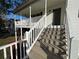 Elevated porch with white railings and wood steps providing outdoor enjoyment at 32 Ne Moriah Way, Rydal, GA 30171
