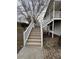Exterior staircase leading to the upper level with white railings and wood steps at 32 Ne Moriah Way, Rydal, GA 30171