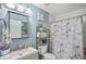 Neat bathroom featuring a modern vanity, toilet, and patterned shower curtain at 340 Lazy Willow Ln, Lawrenceville, GA 30044