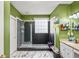 Bathroom featuring a glass shower, tiled floor, granite vanity, and green walls at 340 Lazy Willow Ln, Lawrenceville, GA 30044