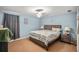 A comfy bedroom with light blue walls, ceiling fan, and neutral bedding at 340 Lazy Willow Ln, Lawrenceville, GA 30044