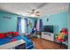 Cheerful bedroom with hardwood floors, ceiling fan and playful decor at 340 Lazy Willow Ln, Lawrenceville, GA 30044