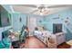 Charming bedroom with hardwood floors, ceiling fan, and a decoratively lit accent wall at 340 Lazy Willow Ln, Lawrenceville, GA 30044