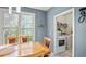 Eat-in dining area by window and laundry room with white walls and marble-like floors at 340 Lazy Willow Ln, Lawrenceville, GA 30044
