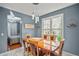 Bright dining room with modern chandelier and large window overlooking outdoor scenery at 340 Lazy Willow Ln, Lawrenceville, GA 30044