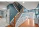 Bright and open entryway featuring hardwood floors and a staircase with white trim and wooden railings at 340 Lazy Willow Ln, Lawrenceville, GA 30044
