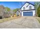 Charming two-story home with a blue garage door, lovely stone accents, and a well-manicured lawn at 340 Lazy Willow Ln, Lawrenceville, GA 30044
