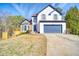 Charming two-story home with a blue garage door, lovely stone accents, and a well-manicured lawn at 340 Lazy Willow Ln, Lawrenceville, GA 30044