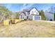 Two-story home with blue garage door, white siding, stone accents, deck, and sloping front yard at 340 Lazy Willow Ln, Lawrenceville, GA 30044